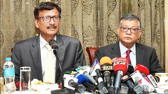 Foreign affairs advisor Touhid Hossain talks to the media as foreign secretary Masud Bin Momen looks on 12 August 2024